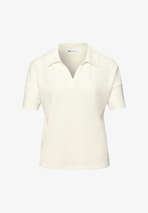 Camiseta de punto de manga corta, color crema, con cuello abierto y textura suave, diseñada para uso casual.