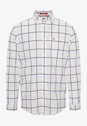 White long-sleeve button-up shirt with navy blue windowpane check pattern, chest pocket, and classic collar, labelled Tommy Jeans.