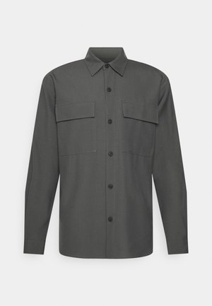Dark gray long-sleeve shirt with button front, pointed collar, and two flap chest pockets on plain background.