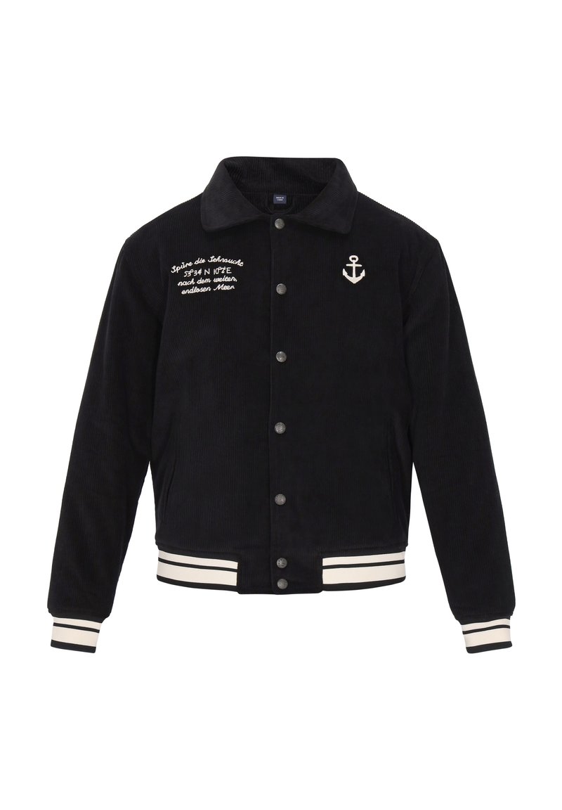 Marineblå kordfløjljakke med knapåbning, hvidt ankerbroderi og stribede ribkanter og nederdel. Har et klassisk kravedesign.