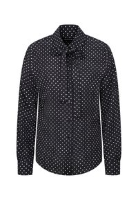 Zwarte blouse met lange mouwen, witte stippen, een knoopsluiting aan de voorkant en een strik bij de kraag.