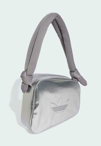 Metallic silver handbag with a padded grey strap, featuring a debossed logo on the front and a zippered closure at the top.