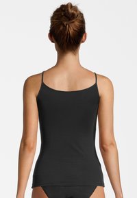 Black, form-fitting tank top with thin straps and a rounded neckline, made from smooth, stretchy fabric. Clean design, no visible patterns.