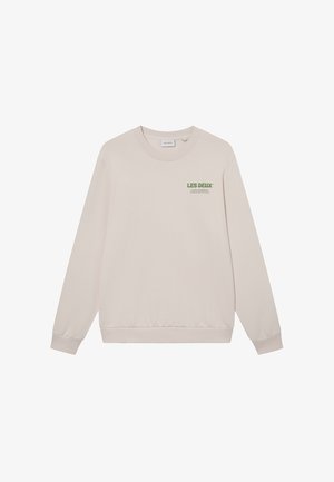 Sweatshirt beige en tissu doux, avec un col rond, des poignets côtelés et un logo imprimé vert sur la poitrine. Design simple et décontracté.