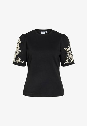 Melna īsroku krekls ar uzpūstām piedurknēm un baltu ziedu izšuvumu uz abām piedurknēm, apaļa kakla izgriezums, pieguloša vidukļa daļa.