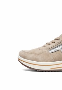 Beige suede sneaker with white and tan thick sole, lace-up design, and metallic silver detail on the side.