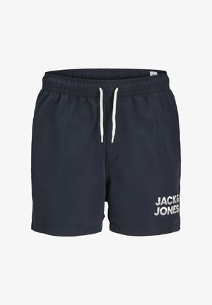 Bañador de color marino hecho de tejido ligero con cintura elástica, cordón blanco y un logo de la marca en el lado inferior.