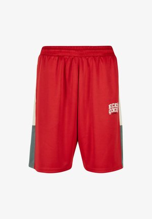 Piros sportnadrág sima szövetből, rugalmas derékkal és fehér logóval a bal lábon. Szürke színblokkolt oldalpanelekkel.