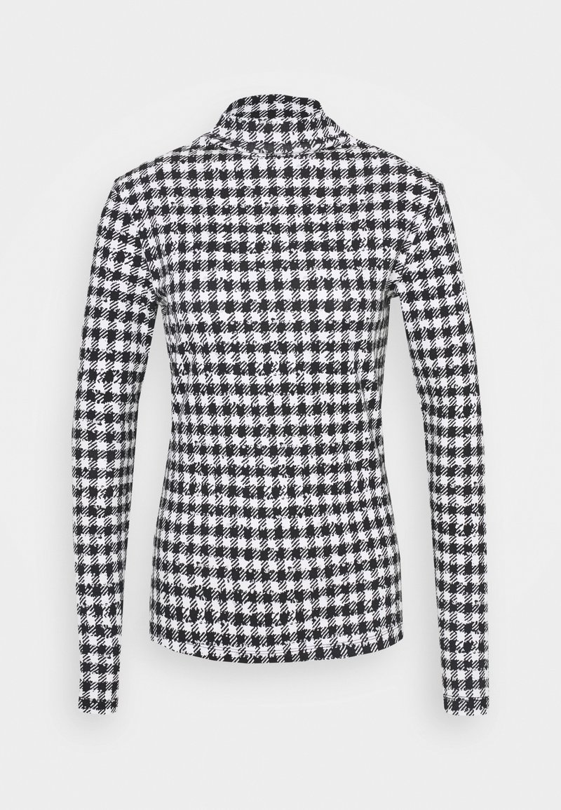 Svart och vit hundtandsmönstrad långärmad skjorta som sitter tight med krage och slätt tyg.
