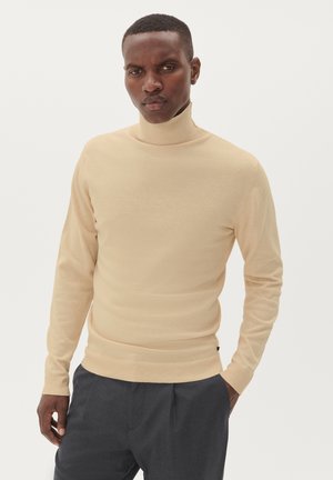 Beiger Rollkragenpullover mit schmaler Passform, langen Ärmeln, geripptem Kragen und Saum. Aus weichem Strickmaterial gefertigt.