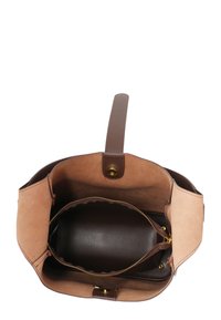 Brown leather handbag with smooth and suede textures, featuring a zippered inner compartment and a short handle. Interior is lined in dark brown.
