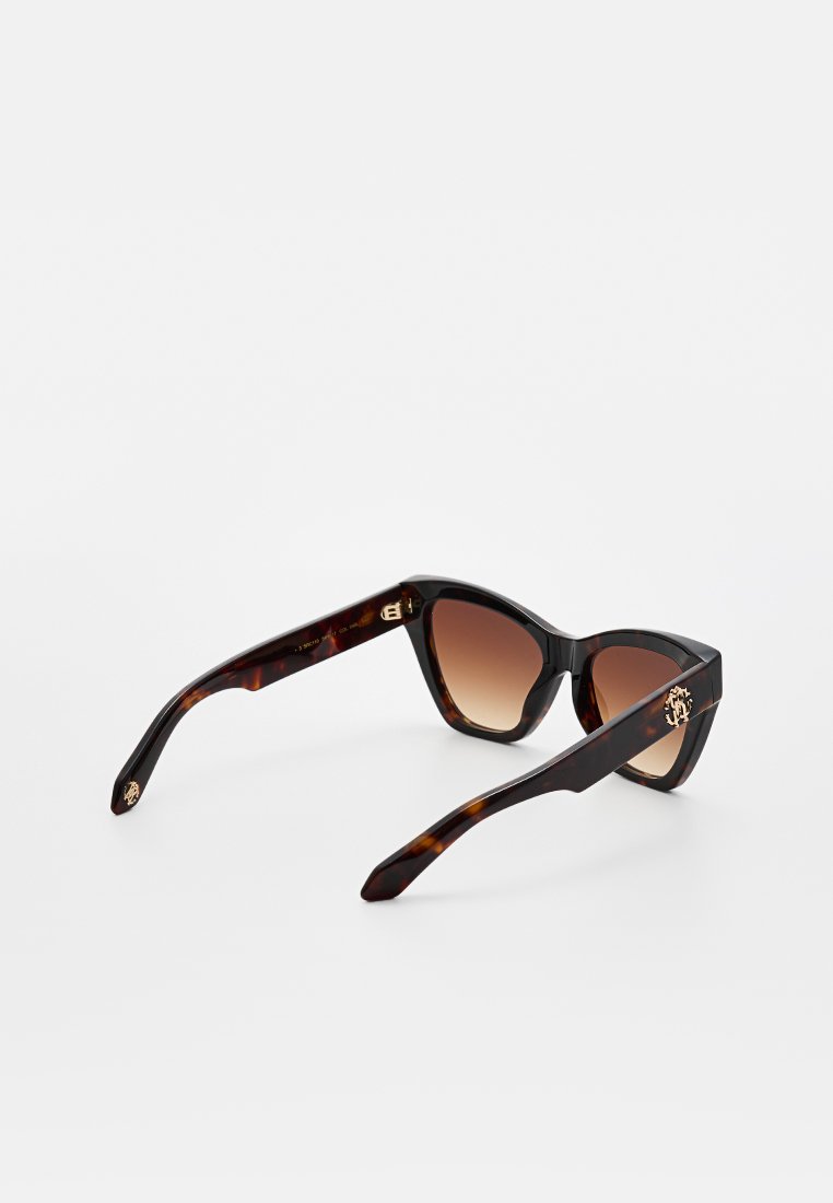 Lunettes de soleil en forme d'œil de chat, en écaille foncée, avec des verres dégradés marron. Présentent des accents de logo en ton doré sur les branches et une finition lisse et brillante.