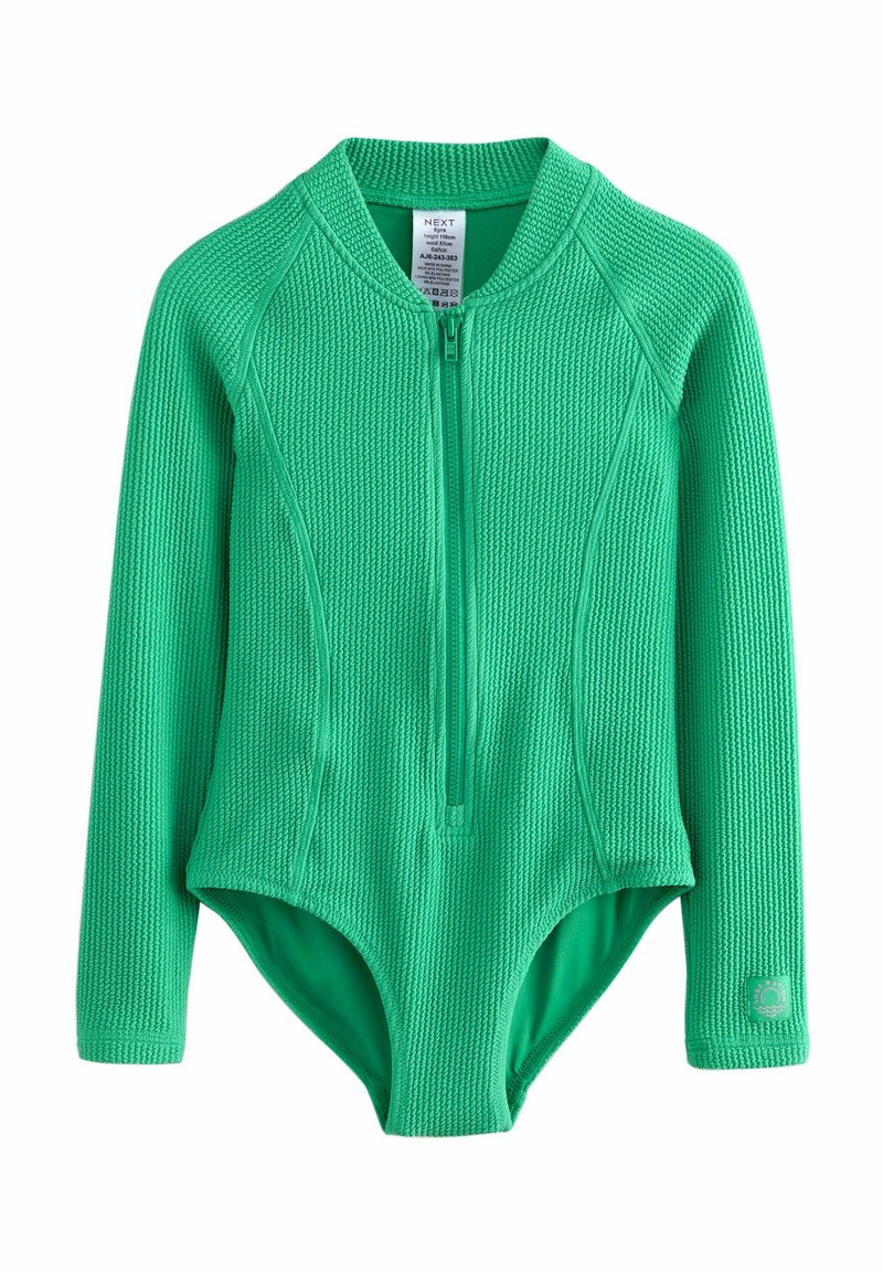 Roheline pika varrukaga bodysuit, mis on valmistatud tekstureeritud kangast, omab eest lukku ja ümmargust kaelust, vasakul varrukal on logo plaaster.