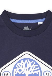T-shirt in cotone blu navy con scollatura rotonda, caratterizzato da una grafica di un albero bianco e blu e dal testo "Est. 73" stampato sul davanti.