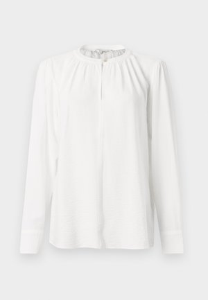 Weißes Langarmblusenshirt mit rundem Halsausschnitt, plissierten Details und einer vorderen Knopfleiste. Hergestellt aus leichtem, strukturiertem Stoff.
