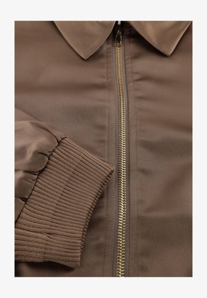 Brown bomber jacket with a gold zipper, featuring a smooth satin finish, ribbed cuffs, and a classic pointed collar design.
