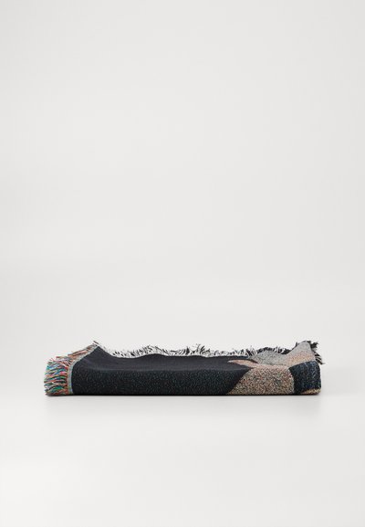 Woven blanket with multicolored fringes, featuring a textured navy fabric and geometric patterns in beige and multicolored yarns.