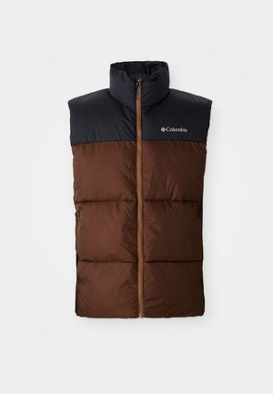 Brūna pūkaina veste ar augstu apkakli, tumši zilā plecu daļa, ar rāvējslēdzēju priekšpusē un pārklājošo tekstūru visā ķermenī. Klātesoša Columbia logo.