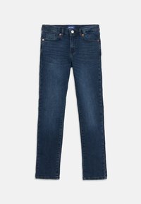 Mörkblå smala jeans med fram- och bakfickor, knappstängning och subtil blekning på lårområdena.