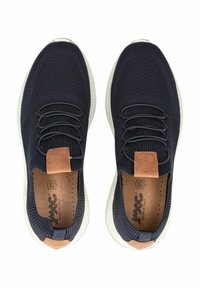Navy mesh sneakers with elastic laces, tan leather accents, white outsoles, and perforated inner soles. Rounded toe and textured surface.