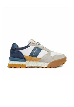Low-top sneaker with white, gray, blue, and mustard panels, lace-up front, and textured gum sole with brand logo on side.