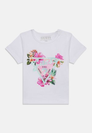 Hvit baby-T-skjorte med korte ermer, rosa og grønt blomsterdesign og glitrende Guess-logo med teksten "U.S.A.", størrelse 3/6 måneder.