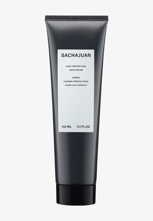 Tubetto nero a pressione con finitura opaca. L'etichetta bianca presenta il nome del prodotto, il volume e un testo bilingue. Contiene 150 mL di crema protettiva dal calore.