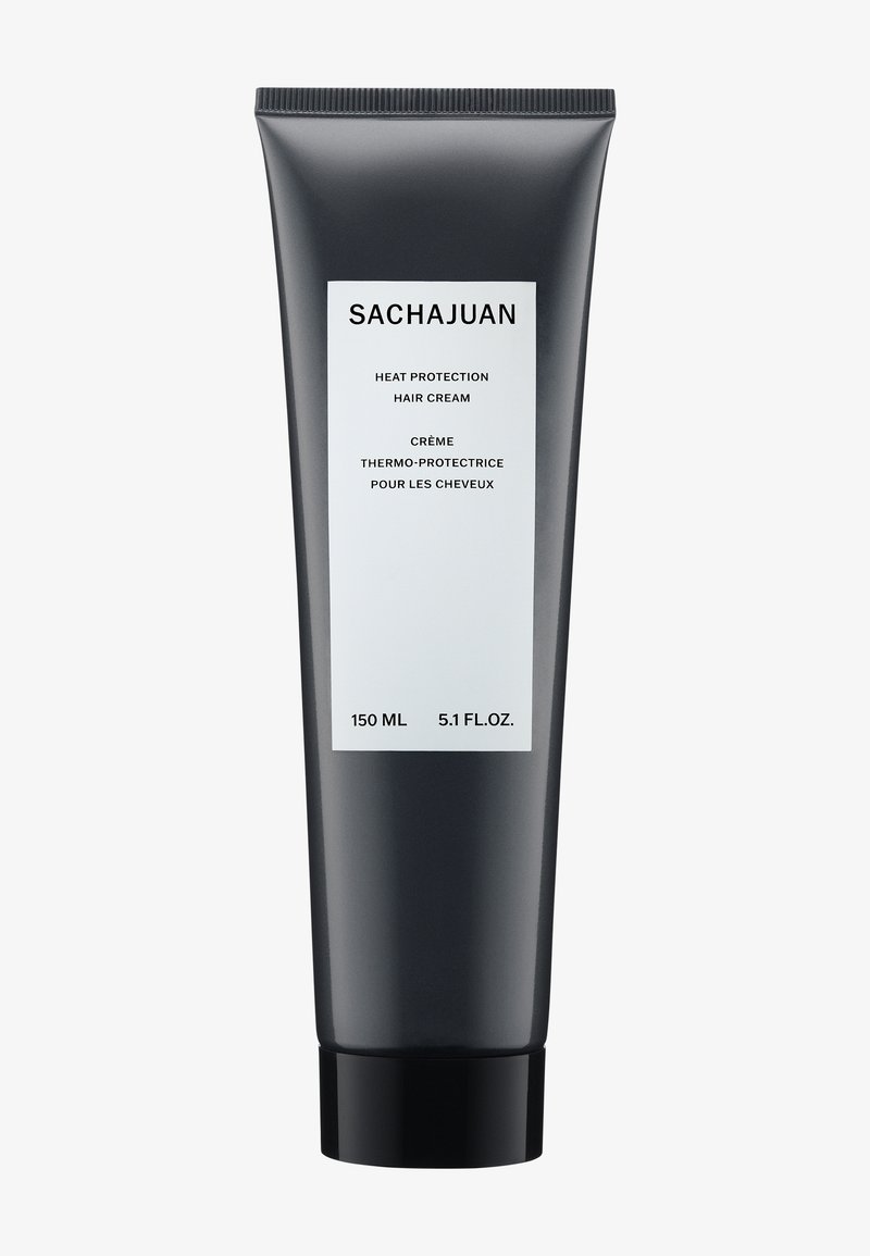 Svart klemrør med matt overflate. Hvit etikett med produktnavn, volum og tospråklig tekst. Inneholder 150 mL med varmebeskyttelseskrem.