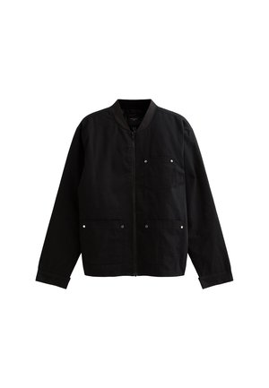 Black zip-up jacket with a round collar, long sleeves, three front pockets, and silver button accents on pockets.