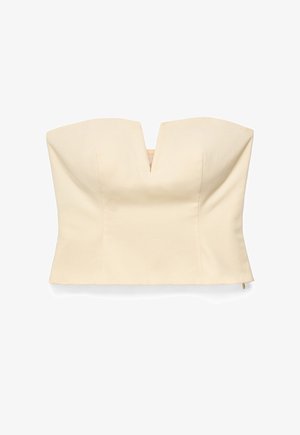 Top bustier sin tirantes color crema con una muesca en forma de V en el centro delantero y costuras estructuradas para una forma ajustada.