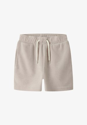 Lyse beige frottéshorts med elastisk linning og hvid snøre, med sidelommer og en afslappet pasform.