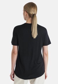 Black short-sleeve t-shirt made of soft cotton. Features a relaxed fit, round neckline, and is plain without patterns or embellishments.