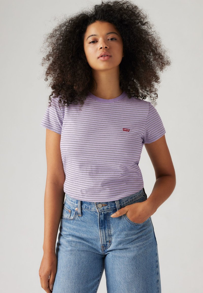 Purple and white striped t-shirt with a round neck and short sleeves, featuring a small red Levi's logo on the chest and a fitted design.