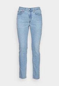 Ljusblå jeans i denim med rak bendesign, fem fickor och knäppning framtill. Tyget har en strukturerad yta.