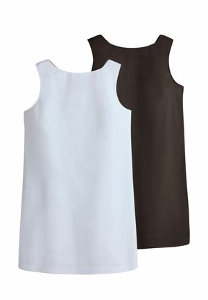 Femme portant une robe sans manches marron foncé longueur genou et des chaussures plates assorties, debout devant un fond clair uni.