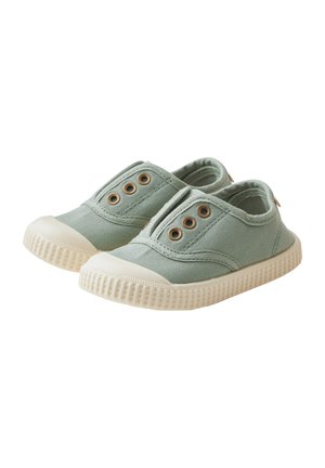 Canvas slip-on shoes in light green with beige rubber sole. Features three brass eyelets, textile upper, and textured rubber outsole.