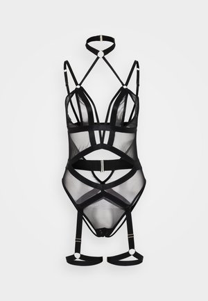 Black sheer bodysuit with various strap designs, featuring geometric cutouts and gold hardware accents at connecting points.