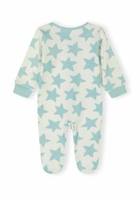 Mono de algodón en color crema con un patrón de estrellas azul claro. Manga larga, diseño con pies y puños suaves alrededor de las muñecas y tobillos.