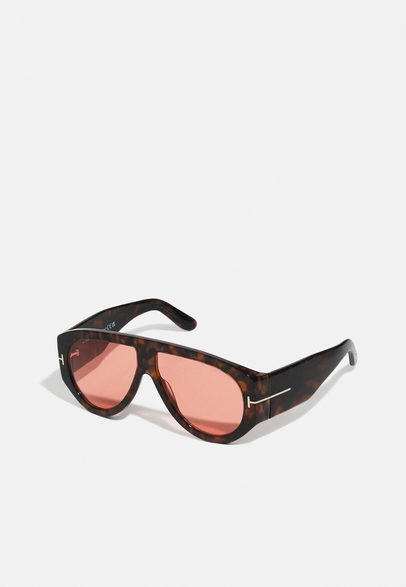 Tortoiseshell sunglasses with pink lenses, featuring a bold angular design and thin silver hardware accents on the frames.