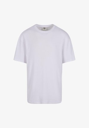 Fehér pamut póló kerek nyakkivágással, rövid ujjakkal és laza szabással. Simább tapintás, minta nélkül, minimalista dizájn.