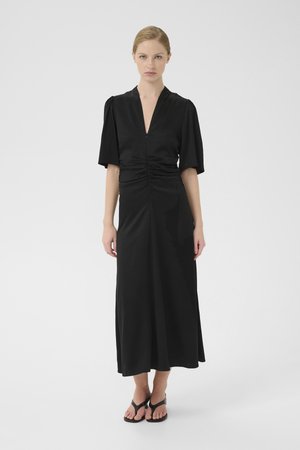 Black maxi dress with a v-neck and short puff sleeves. Features ruched detailing at the waist and a smooth, flowing fabric.