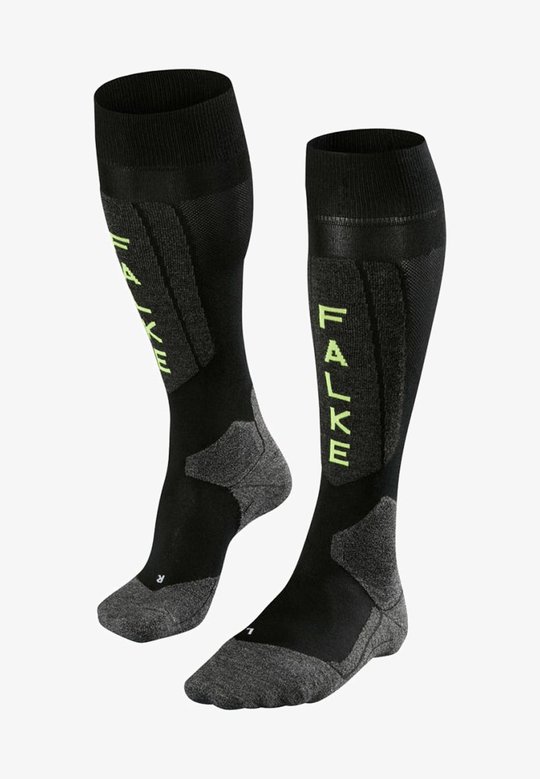 Knielange schwarze Socken mit strukturierten Einsätzen und limegrüner "FALKE"-Markierung. Verstärkter Fersen- und Zehenbereich mit dunkelgrauen Akzenten.