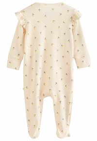 Bodysuit crème avec des manches longues et des accents volants. Décoré de motifs de citrons jaunes et de feuilles bleues, fabriqué en tissu doux.