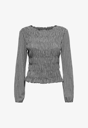 Svart-hvitt gingham langermet bluse med rynket stoff, rund halslinning, innsvingt midje og volangkant.