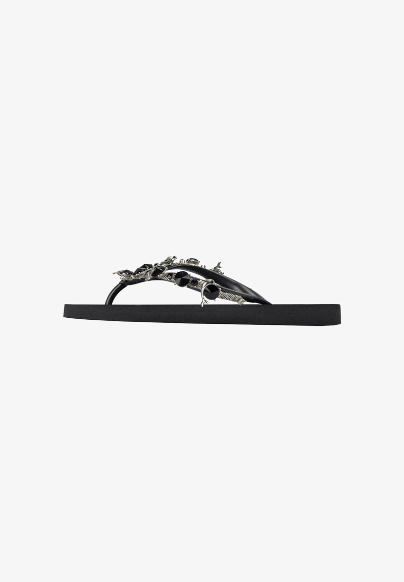 Black flip-flop with a textured sole, featuring embellished straps with metallic accents and decorative elements, providing a unique design.