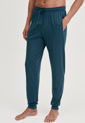 Turquoise loungebroeken gemaakt van zachte stof, met een elastische tailleband, een trekkoord, zijzakken en taps toelopende manchetten.