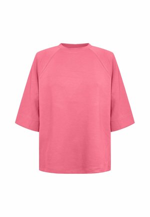 T-shirt rose à manches courtes en coton, col rond et manches raglan. Texture lisse, coupe ample, sans motifs ni accents visibles.