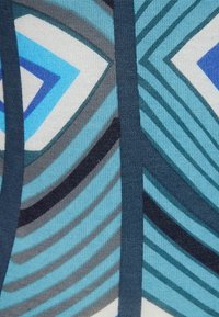 Blau- und grau-geometrisch gemusterter Stoff mit welligen Linien und scharfen Formen. Das Material hat ein strukturiertes, gewebtes Aussehen.