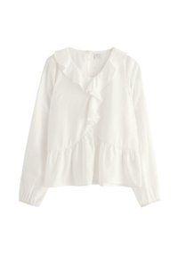 Vit långärmad blus med volangkrage och volang framtill, texturerad bomull med prickar, elastiska ärmslut och en rynkad peplumslut.