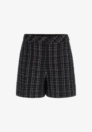 Schwarz-weiße Karoshorts aus strukturiertem Stoff. Sie haben eine hohe Taille mit einem gewebten Bund und sichtbaren Nahtdetails.